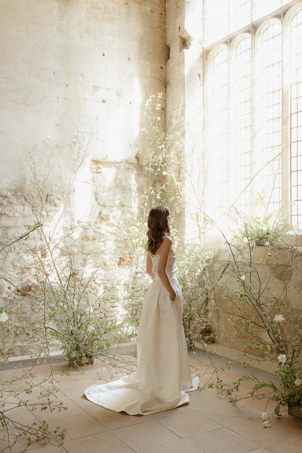 Bride in Blackfriars Priory surrounded by floral design installation Photo ©Aga Hosking