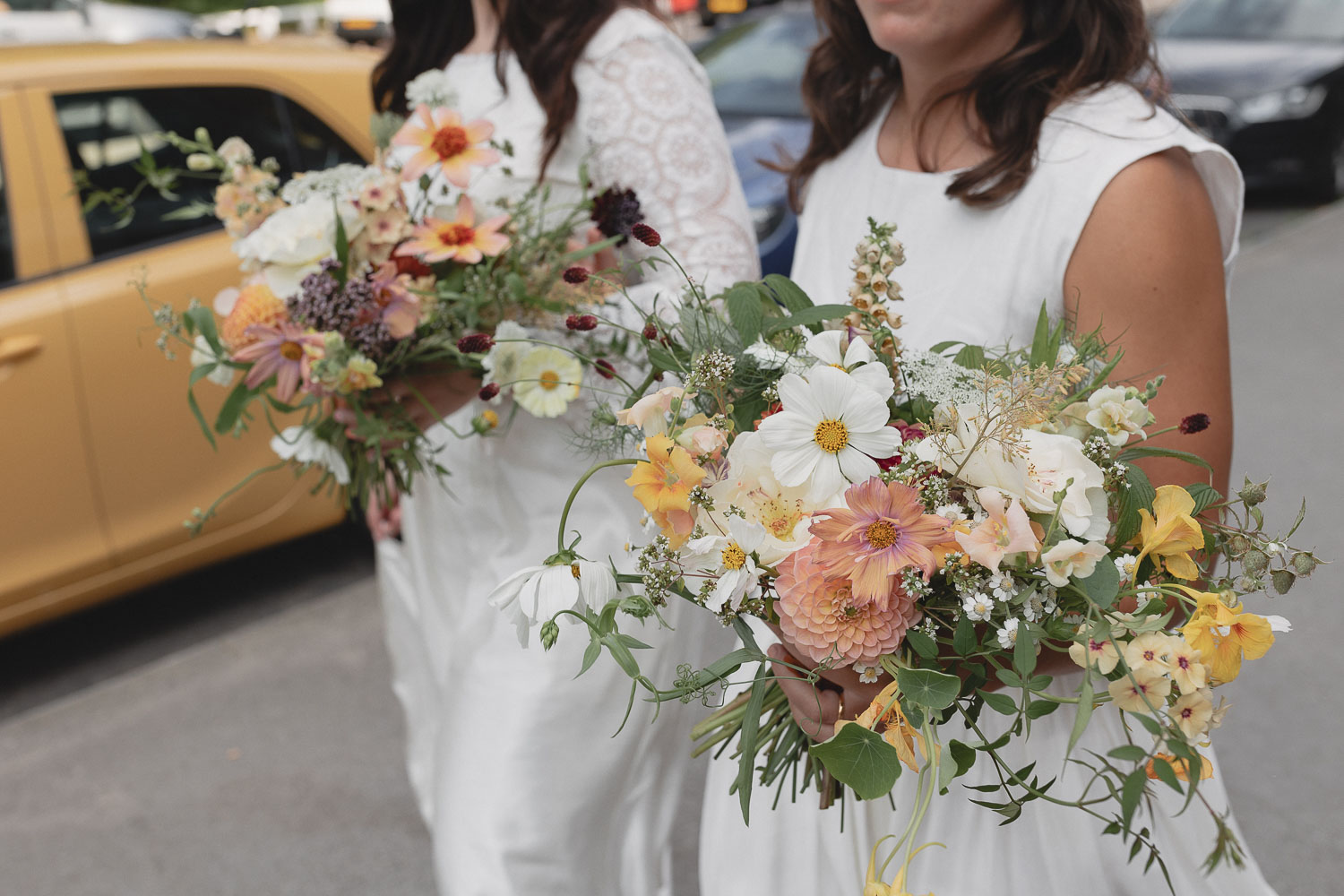Two brides with bouquets. Photo ©Daisy Price Photography