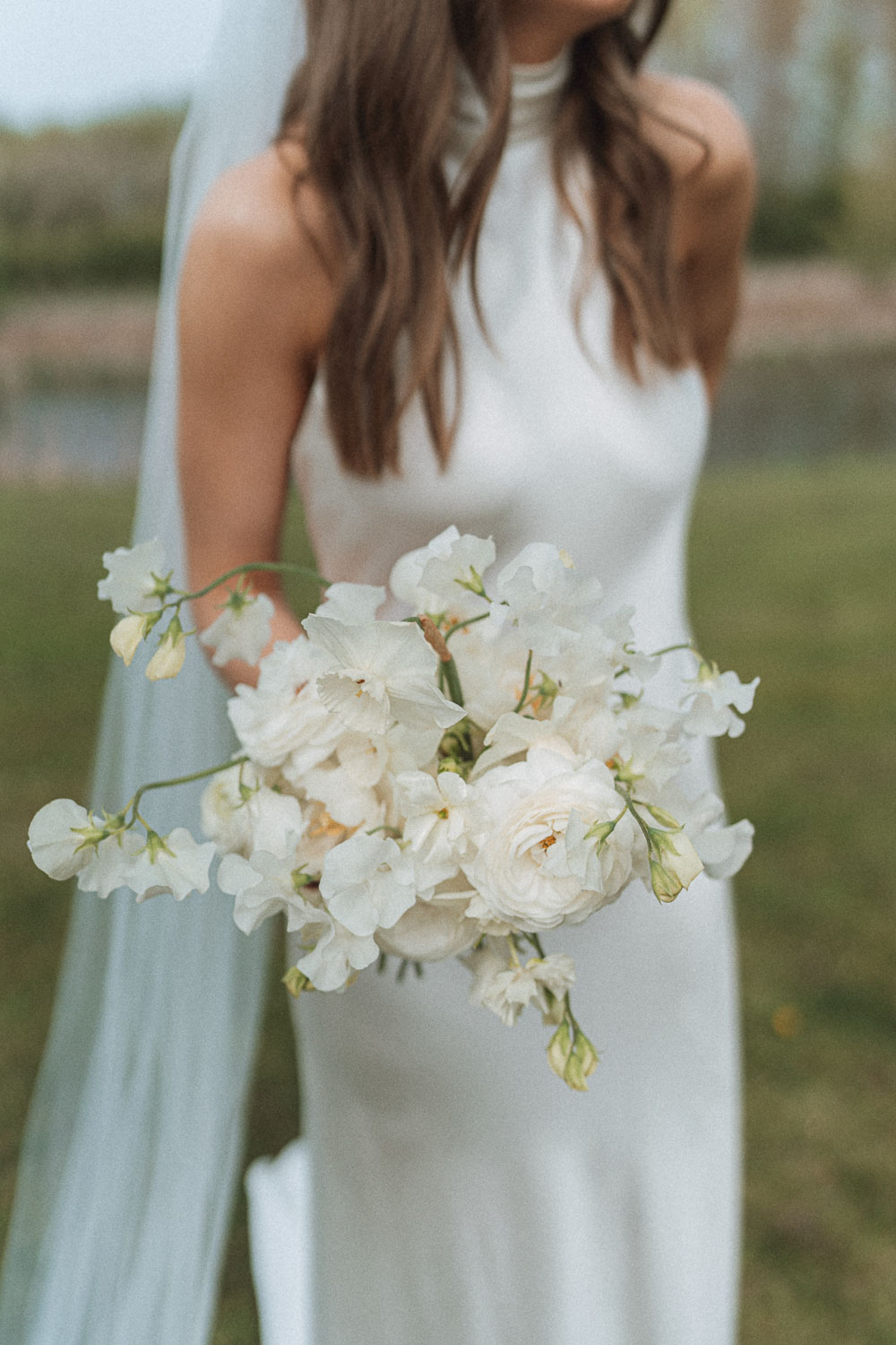 Bride holding bouquet. Photo ©Abi Buck Photography