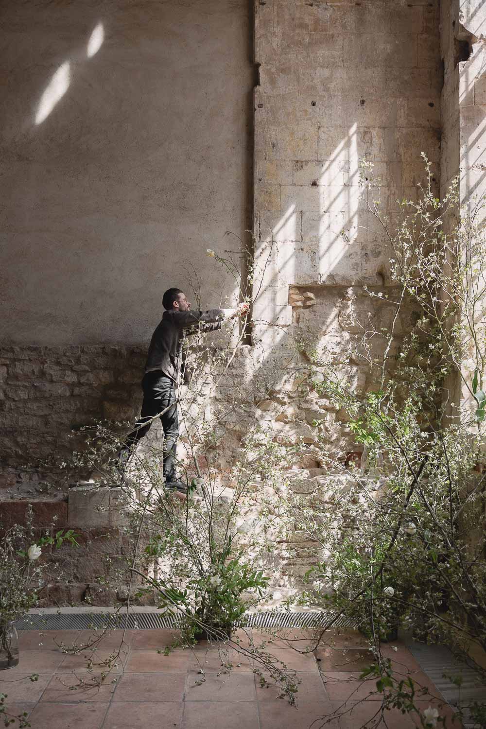 Sam placing branch into installation at Blackfriars Priary. Photo ©Daisy Price Photography